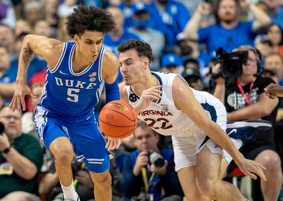 Duke’s Tyrese Proctor (5) makes a steal from Virginia’s Francisco Caffaro (22) during the first half in the championship game of the ACC Tournament on Saturday, March 11, 2023 at the Greensboro Coliseum in Greensboro, N.C