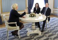 French far-right presidential candidate Marine Le Pen, left, gestures while speaking to Russian President Vladimir Putin, right, during their meeting in the Kremlin in Moscow, Russia, Friday, March 24, 2017. Putin has held a surprise meeting with France’s far-right presidential candidate and dismissed suggestions that Russia aims to influence the election in her favor. (Mikhail Klimentyev, Sputnik, Kremlin Pool Photo via AP)