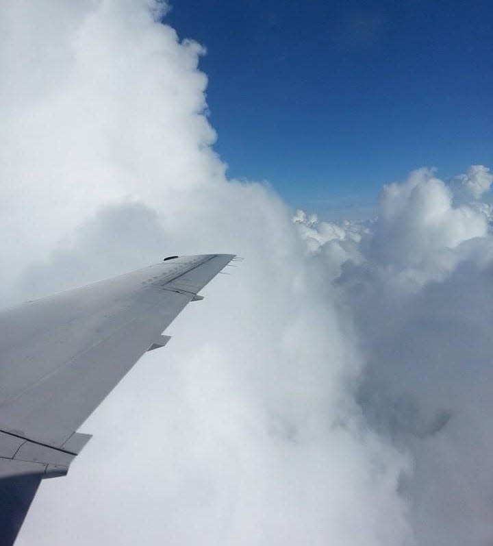 This 2013 aerial photograph shows the darkening sky over central Illinois heralding the approach of a tornado that would cause extensive damage in Pekin and Washington.