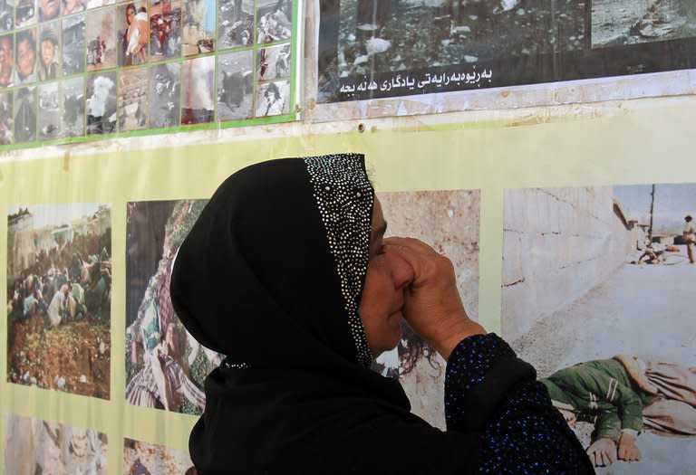 A Kurdish woman cries as she looks at pictures of victims of a 1988 gas attack by former Iraqi dictator Saddam Hussein, at the memorial site of the attack in the Kurdish town on Halabja