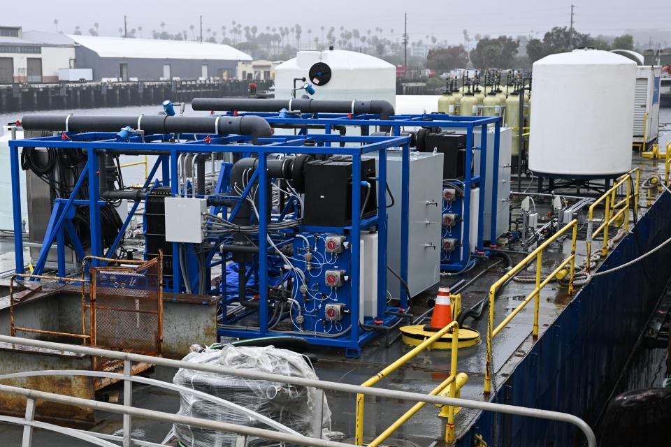 Equipment including an electrochemical reactor where seawater is split via electrolysis to capture carbon on a barge for UCLA's SeaChange climate change carbon removal project at the Port of Los Angeles in San Pedro, California on April 12, 2023. - Floating in the port of Los Angeles, a strange-looking barge covered with pipes and tanks contains a concept that scientists hope to make waves: a new way to use the ocean as a vast carbon dioxide sponge to tackle global warming.
Scientists from University of California Los Angeles (UCLA) have been working for two years on SeaChange -- an ambitious project that could one day boost the amount of CO2, a major greenhouse gas, that can be absorbed by our seas. (Photo by Patrick T. Fallon / AFP) (Photo by PATRICK T. FALLON/AFP via Getty Images)