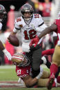 Tampa Bay Buccaneers quarterback Tom Brady (12) looks to pass while pressured by San Francisco 49ers defensive end Nick Bosa (97) during the first half of an NFL football game in Santa Clara, Calif., Sunday, Dec. 11, 2022. (AP Photo/Tony Avelar)