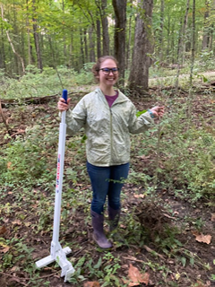 Hannah Martin, education specialist with the Lawrence County Soil and Water Conservation District, is shown with a privet tree after having uprooted it with the new Uprooter tool next to her.