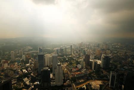 A rain storm clears over central Kuala Lumpur, Malaysia August 16, 2014. REUTERS/Olivia Harris/File Photo