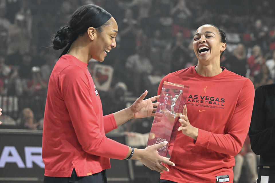 Las Vegas Aces forward A'ja Wilson hands her 2023 WNBA Defensive Player of the Year award to center Kiah Stokes during the award ceremony prior to Game 1 of the WNBA semifinals at Michelob Ultra Arena in Las Vegas on Sept. 24, 2023. (Photo by Candice Ward/Getty Images)