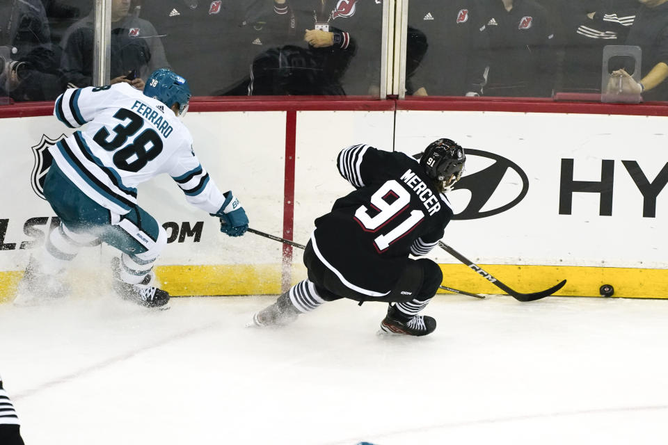 San Jose Sharks defenseman Mario Ferraro (38) pursues New Jersey Devils center Dawson Mercer (91) during the second period of an NHL hockey game in Newark, N.J., Friday, Dec. 1, 2023. (AP Photo/Peter K. Afriyie)