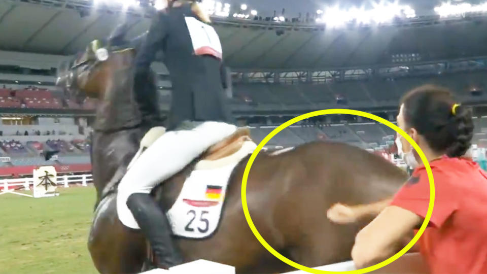 Germany's modern pentathlon coach Kim Raisner (pictured right) allegedly hitting the horse at the Olympics.