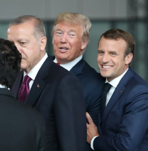 France's President Emmanuel Macron (R) jokes with US President Donald Trump (C) next to Turkey?s President Recep Tayyip Erdogan as they gather for the NATO summit