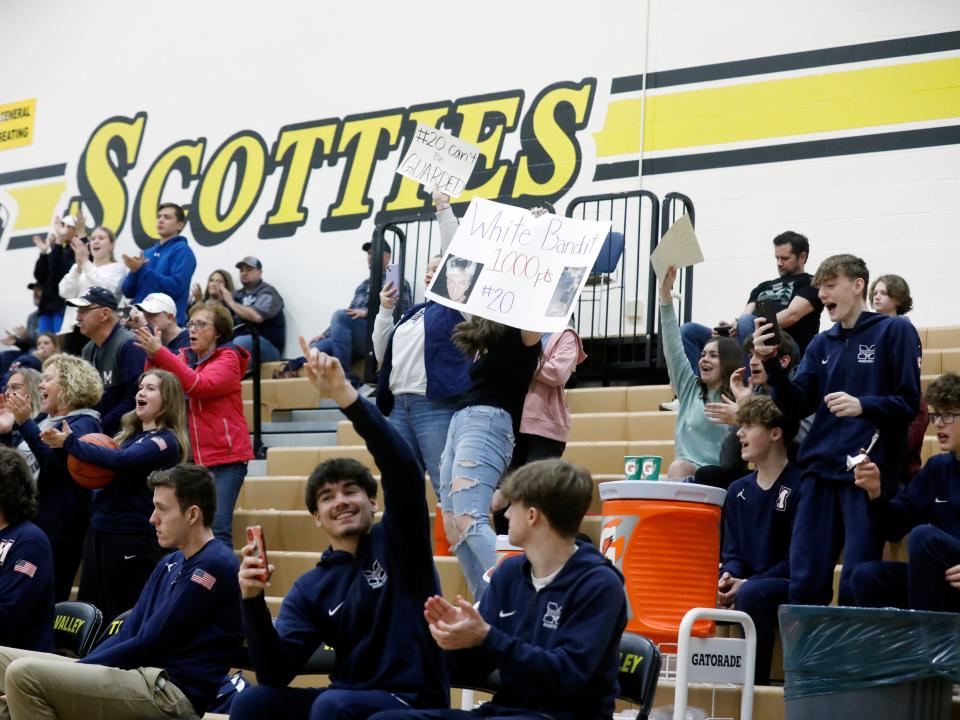 Morgan fans cheer after Carson Mummey scores his 1,000th career point during Morgan's 72-29 loss to Tri-Valley on Friday night in Dresden.