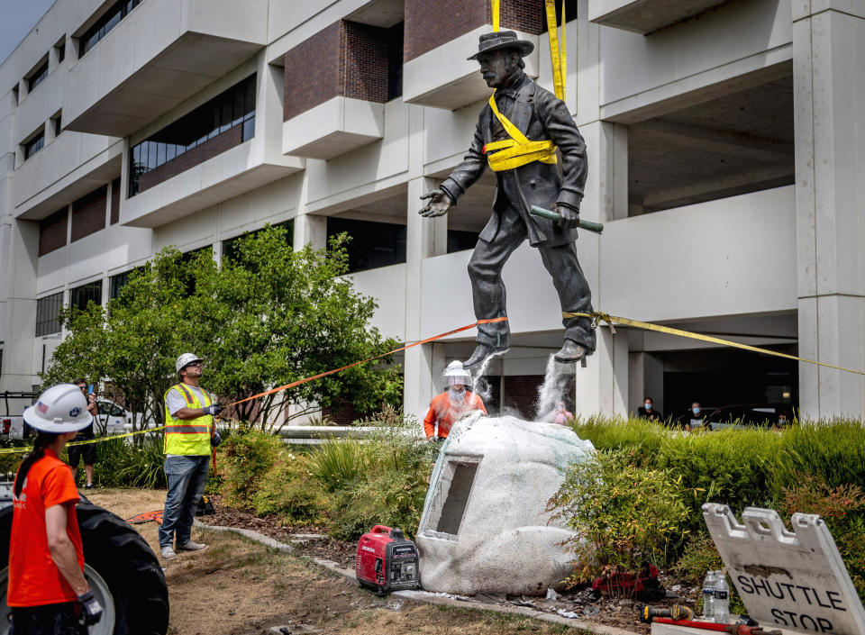 Workers remove a statue of John Sutter, a Swiss settler who built the first European settlement on the site of the city of Sacramento, outside Sutter hospital in midtown on Monday, June 15, 2020. Some historical accounts describe Sutter as using Native Americans as slaves and raping Native American girls. (Daniel Kim/The Sacramento Bee via AP)