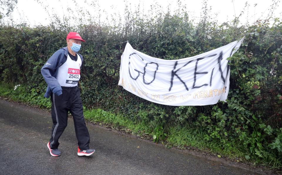 Ken Jones, 87, takes part in the historic first virtual London Marathon during gale-force winds and rain in his home town of Strabane, west Tyrone (PA)