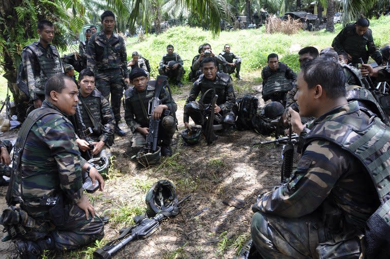 This photo, taken on March 14, 2013 and released by the Malaysia Ministry of Defence, shows Malaysian soldiers preparing for an operation in the area of Sungai Nyamuk where Filipino gunmen were locked down in a stand-off in the surrounding villages of Tanduo, in Sabah