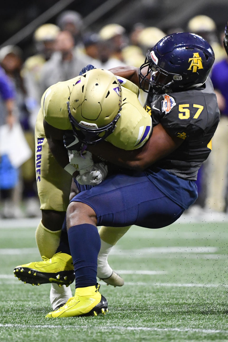 North Carolina A&T linebacker Jacob Roberts (57) brings down Alcorn State tight end Jerimiah Green during the first half of the Celebration Bowl NCAA college football game, Saturday, Dec. 21, 2019, in Atlanta. (John Amis/Atlanta Journal-Constitution via AP)