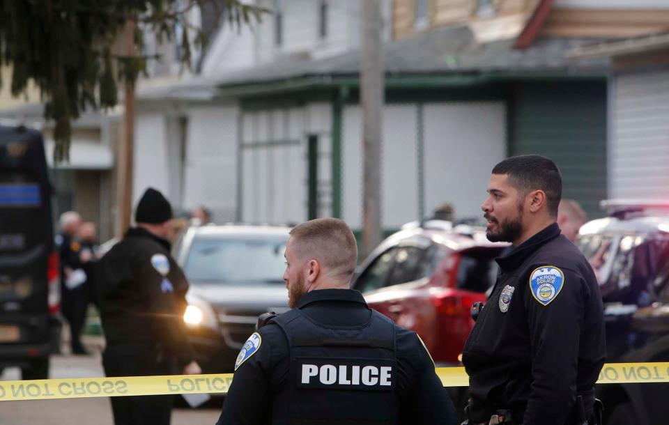 Akron police secure the scene of a shooting Thursday in Akron's North Hill neighborhood.