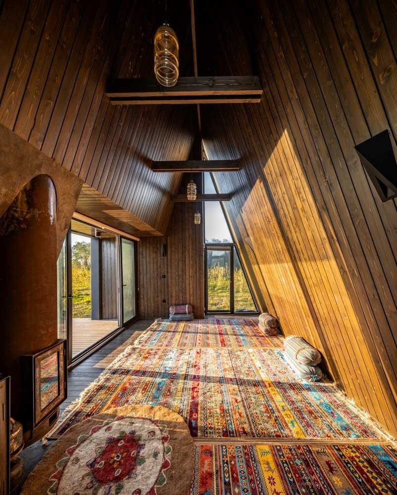 Cozy carpeted interiors of the Shaygan Gostar-designed Wicker House A-frame cabin.