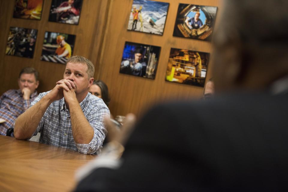 Powell listens&nbsp;as Walton talks.