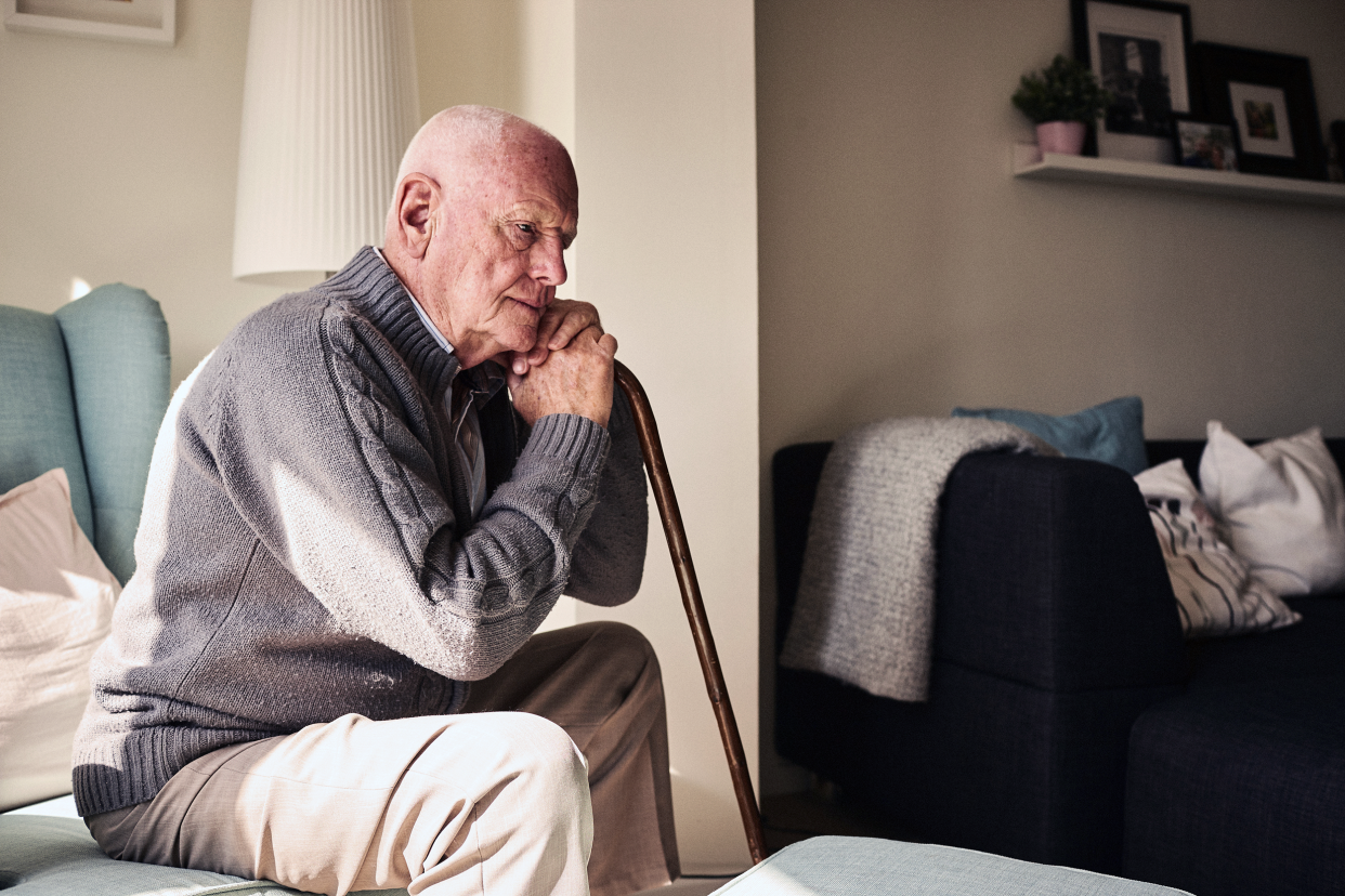 Depressed senior man sitting at home