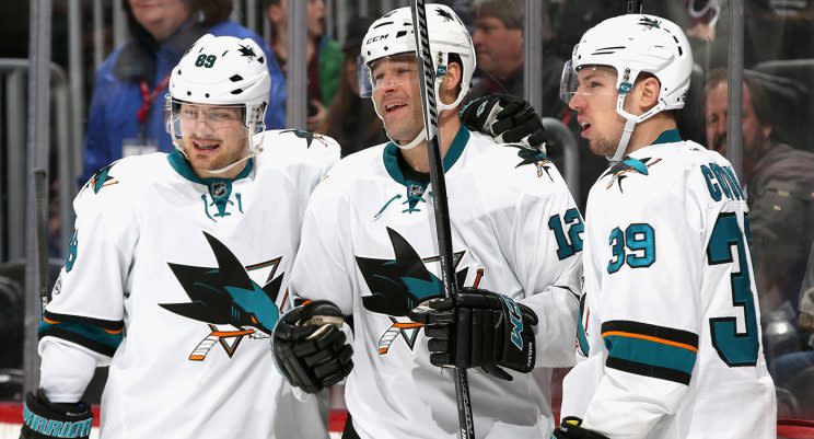 Patrick Marleau (12) of the San Jose Sharks is congratulated by Mikkel Boedker (89) and Logan Couture (39) after scoring against the Colorado Avalanche. (Matthew Stockman/Getty Images)