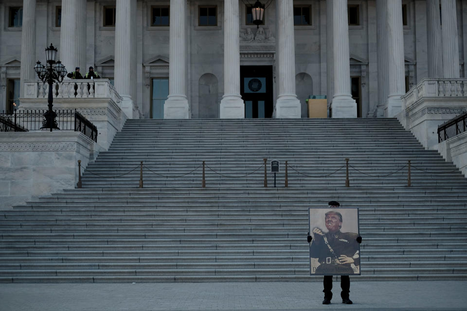 A protestor demonstrates against President Donald Trump in front of the Capitol during the senate impeachment trial in Washington, D.C., on Jan. 29, 2020. | Gabriella Demczuk for TIME