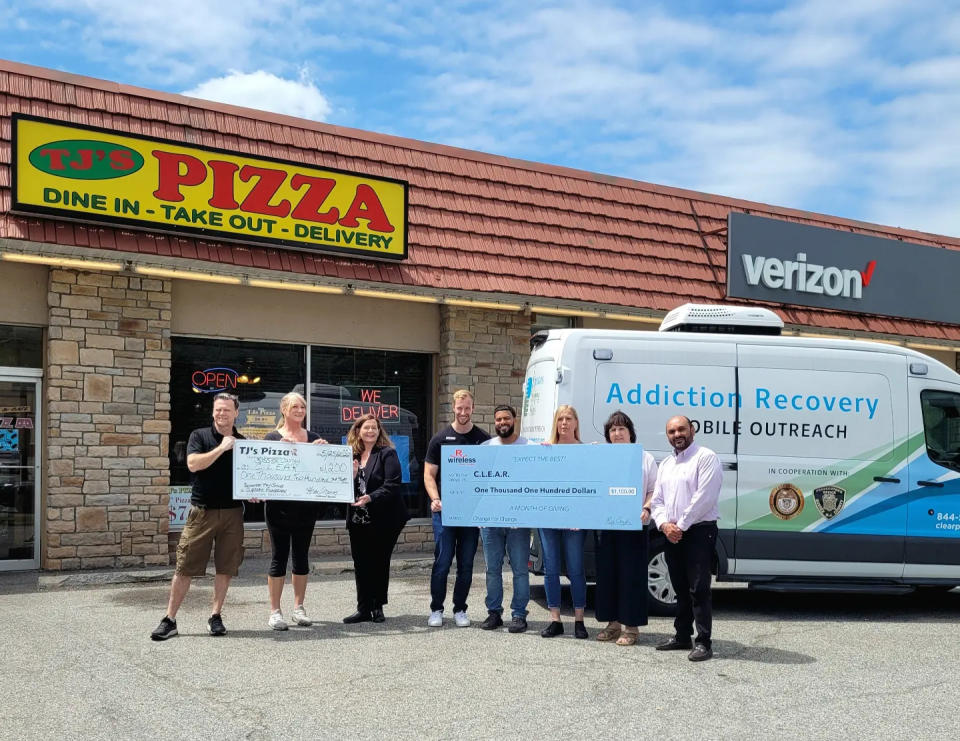 Employees from TJ's Pizza and R-Wireless in Franklin hold two checks totaling $2,300 from a pair of fundraisers benefiting the Sussex County C.L.E.A.R. (Community Law Enforcement Addiction Recovery) program Wednesday, May 25, 2022.