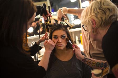 A model has make up applied before the GS Shop Lingerie Show featuring Wonderbra, Anna Sui and Spanx Fall 2014 collections during New York Fashion Week February 4, 2014. REUTERS/Eric Thayer