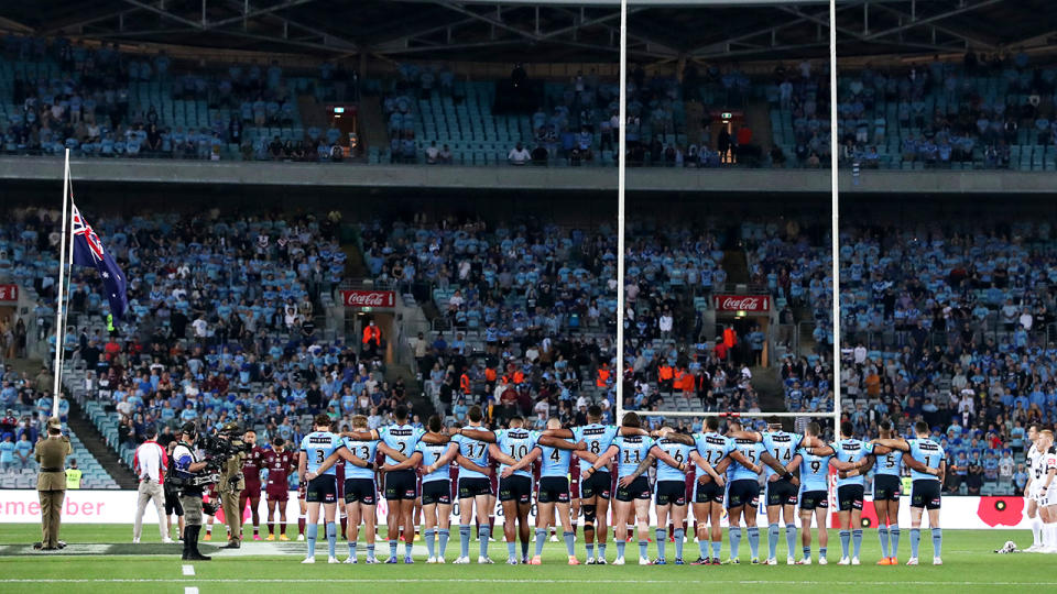 Fans and players, pictured here during a minute of silence at State of Origin.