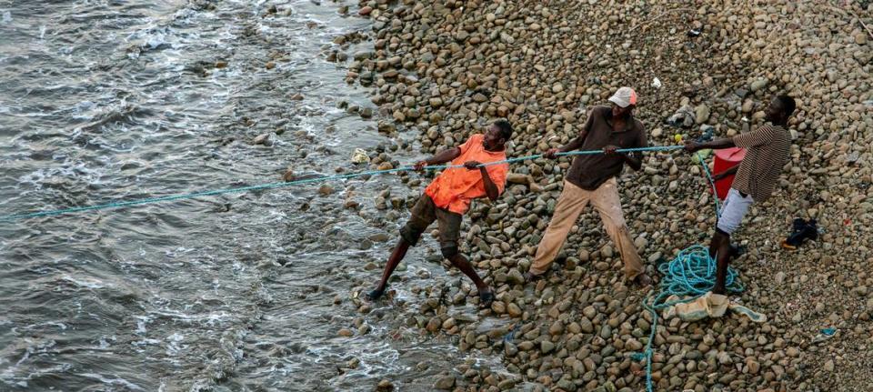 Men from the fishing community of Bodin on the outskirts of Port-de-Paix pull in a fishnet on March 24, 2022. Residents here say the lack of jobs and fish are among the reasons some have taken their chances trying to get to the Florida Keys on flimsy vessels. Jose A. Iglesias/jiglesias@elnuevoherald.com