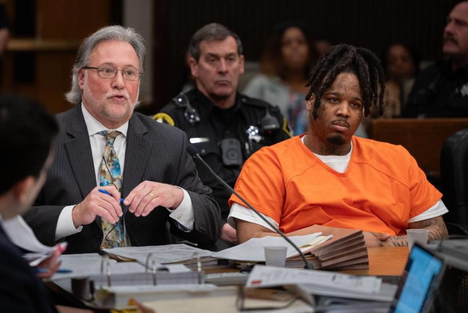 District Attorney Norm Dawson questions a witness as murder suspect Smiley Martin, 23, listens during a preliminary hearing in Sacramento Superior Court Friday, Feb. 23, 2024, in the case of the April 2022 mass shooting in downtown Sacramento.