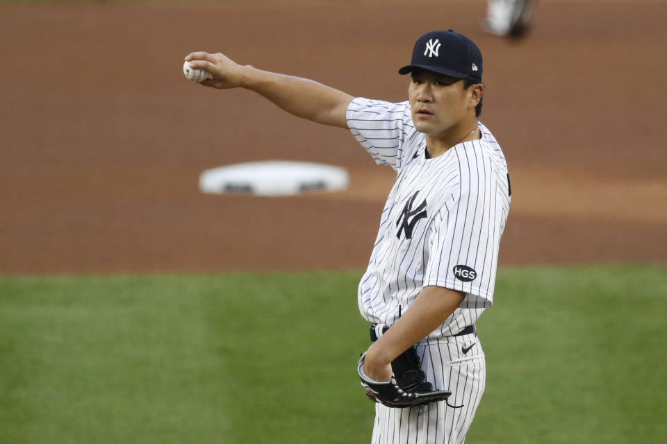 New York Yankees starting pitcher Masahiro Tanaka stretches out his arm before warming up before the start of a baseball game, Tuesday, Aug. 18, 2020, in New York. (AP Photo/Kathy Willens)