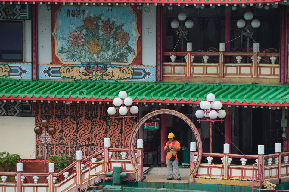 Hong Kong's iconic Jumbo Floating Restaurant is towed away in Hong Kong, Tuesday, June 14, 2022. Hong Kong's iconic restaurant on Tuesday departed the city, after its parent company failed to find a new owner and lacked funds to maintain the establishment amid months of COVID-19 restrictions. (AP Photo/Kin Cheung)