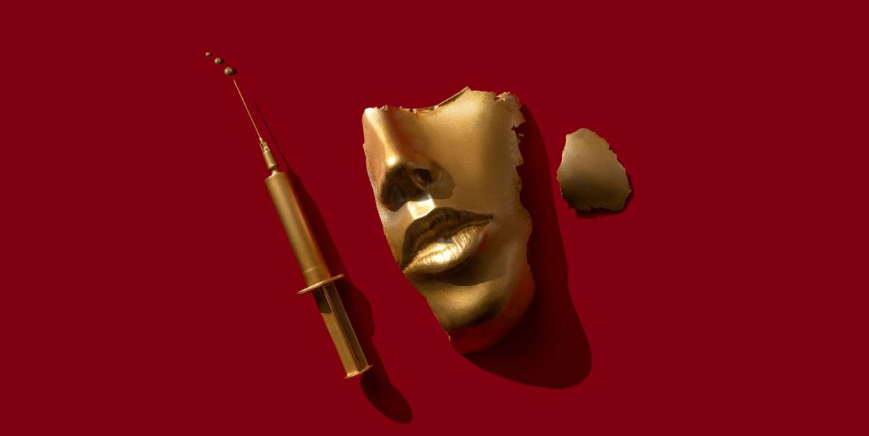 gold colored syringe and face mask on the red background