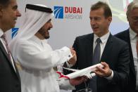 Airbus CEO Guillaume Faury, right, shakes hands with Air Arabia chairman Sheikh Abdullah bin Mohammed al-Thani at the Dubai Airshow in Dubai, United Arab Emirates, Monday, Nov. 18, 2019. The Emirati budget carrier Air Arabia announced Monday the purchase of 120 new Airbus planes in deal worth $14 billion. (AP Photo/Jon Gambrell)