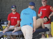 Michael Phelps gets a massage after practice, Wednesday, April 23, 2014, in Mesa, Ariz. Phelps is competing in the Arena Grand Prix at Mesa as he returns to competitive swimming after a nearly two-year retirement. (AP Photo/Matt York)