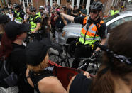 <p>A group wearing anit-facist attire is directed by law enforcement as they march ahead of the one-year anniversary of 2017 Charlottesville “Unite the Right” protests, in Charlottesville, Va., Aug. 11, 2018. (Photo: Jim Urquhart/Reuters) </p>