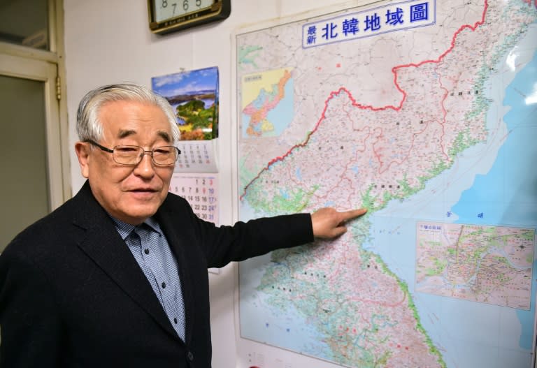 Shim Goo-Seob, the president of an association that organises private sector reunions between separated families, points to his hometown on the map of North Korea during an interview with AFP at his office in Seoul