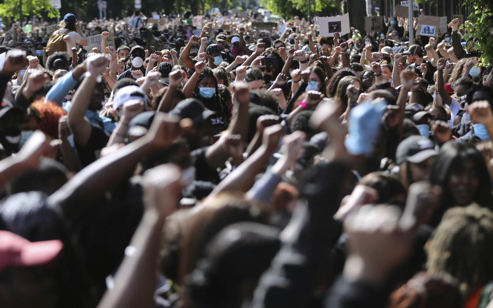 People protest under the slogan Black Lives Matter and I Can't Breathe, as they rally outside the US Embassy in Dublin, Ireland, Monday June 1, 2020, following the recent death of George Floyd in Minneapolis, USA. Floyd died after a US officer pressed his knee into his neck for several minutes even after he stopped moving and pleading for air. (Niall Carson / PA via AP)