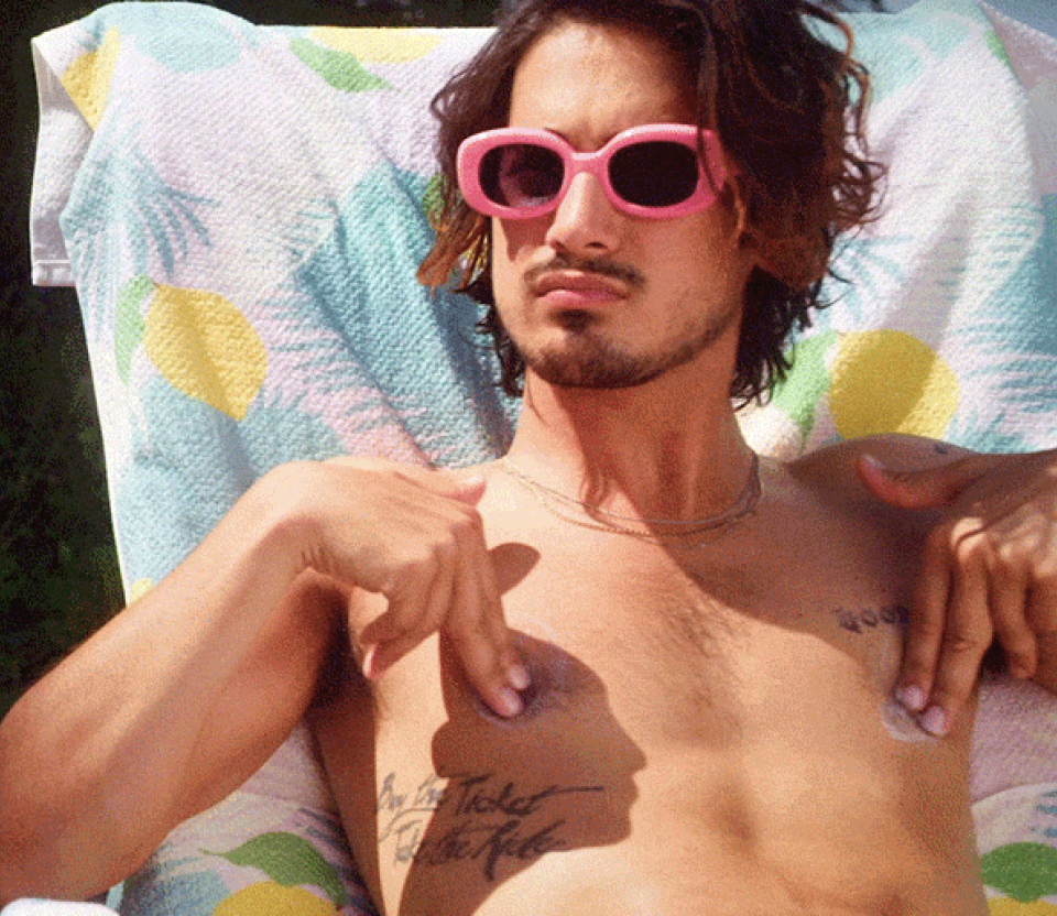 Avan Jogia applying sunscreen to his nipples in "Now Apocalypse"