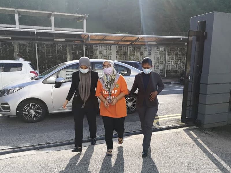 The 40-year-old suspect (centre) is led to the Johor Baru Magistrate’s Court by Johor MACC officers April 20, 2021. — Picture courtesy of Johor Malaysian Anti-Corruption Commission