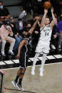 Milwaukee Bucks' Pat Connaughton, right, shoots over Brooklyn Nets' James Harden, left, during the second half of Game 7 of a second-round NBA basketball playoff series Saturday, June 19, 2021, in New York. (AP Photo/Frank Franklin II)