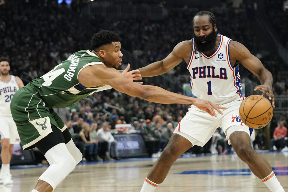 Philadelphia 76ers' James Harden (1) controls the ball against Milwaukee Bucks' Giannis Antetokounmpo during the first half of an NBA basketball game Saturday, March 4, 2023, in Milwaukee. (AP Photo/Aaron Gash)