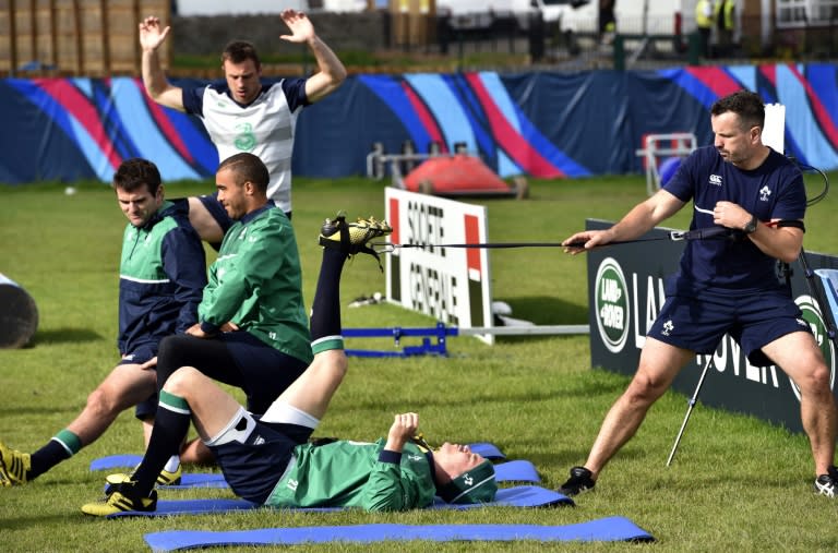 Ireland's fly-half Jonathan Sexton stretches with teammates during a team training session in Newport, south Wales, on October 9, 2015, during the Rugby World Cup