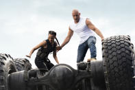 This image released by Universal Pictures shows Nathalie Emmanuel, left, and Vin Diesel in a scene from "F9." Universal Pictures announced that the “Fast and Furious” movie titled “F9” would not open May 22 as planned but in April next year due to the coronavirus. For most people, the new coronavirus causes only mild or moderate symptoms. For some it can cause more severe illness. (Giles Keyte/Universal Pictures via AP)