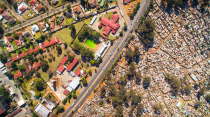<p>Miller’s shots of South Africa show large houses sitting next to dwellings made out of scrap and tin (MediaDrumWorld/Johnny Miller) </p>