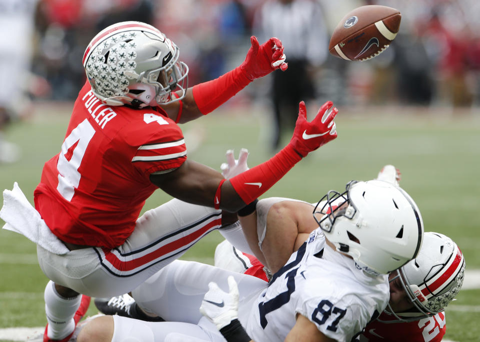 FILE - In this Nov. 23, 2019, file photo, Ohio State defensive back Jordan Fuller, left, breaks up a pass intended for Penn State tight end Pat Freiermuth during the first half of an NCAA college football game, in Columbus, Ohio. Fuller was selected to The Associated Press All-Big Conference team, Wednesday, Dec. 11, 2019.(AP Photo/Jay LaPrete, File)