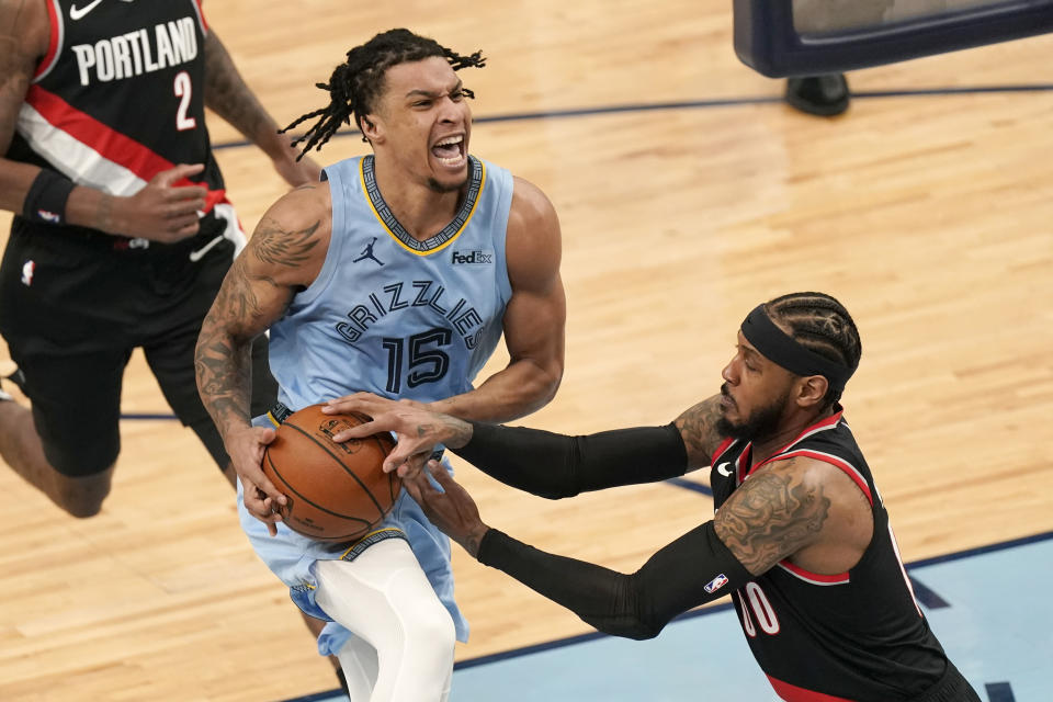 Memphis Grizzlies' Brandon Clarke (15) drives against Portland Trail Blazers' Carmelo Anthony (00) in the first half of an NBA basketball game Wednesday, April 28, 2021, in Memphis, Tenn. (AP Photo/Mark Humphrey)