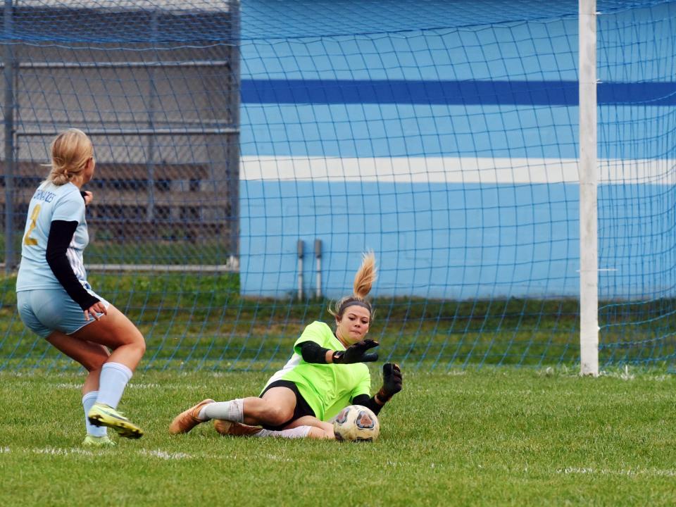 Goalie Alison Yingling makes a sliding stop during the first half of Tri-Valley's 6-0 win against host West Muskingum on Thursday in Falls Township.