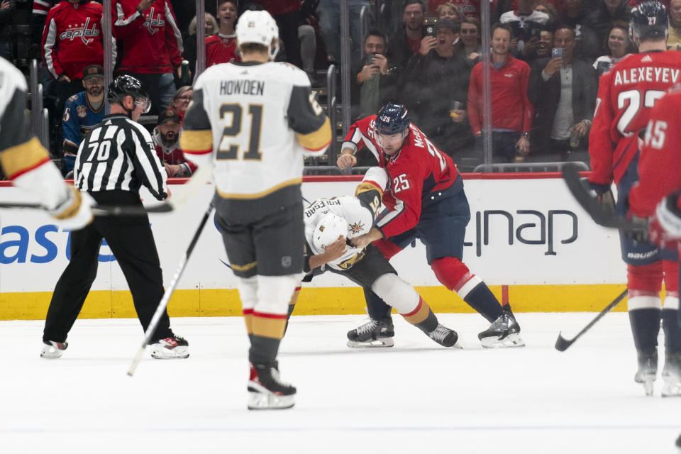 Washington Capitals defenseman Dylan McIlrath (25) and Vegas Golden Knights right wing Keegan Kolesar scuffle in the first period of an NHL hockey game, Tuesday, Nov. 14, 2023, in Washington. (AP Photo/Stephanie Scarbrough)