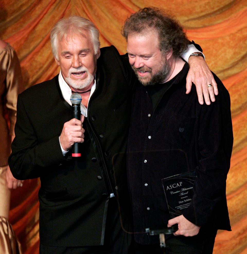 Kenny Rogers, left, presents the ASCAP Creative Achievement Award to songwriter Don Schlitz during the ASCAP Country Music Awards show Oct. 15, 2007. Among the songs Schlitz has written is the Rogers hit, "The Gambler."