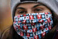 Zoe Wynn, a sophomore at Bates College, from Mill Valley, Calif., wears a mask to help prevent the spread of the coronavirus while attending a campaign event held by Democratic candidate for Senate, Sara Gideon, Friday, Oct. 30, 2020, in Lewiston, Maine. (AP Photo/Robert F. Bukaty)