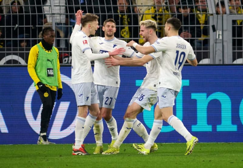 Hoffenheim's Maximilian Beier (L) celebrates scoring his side's third goal with teammates during the German Bundesliga soccer match between Borussia Dortmund and TSG 1899 Hoffenheim at Signal Iduna Park. Bernd Thissen/dpa